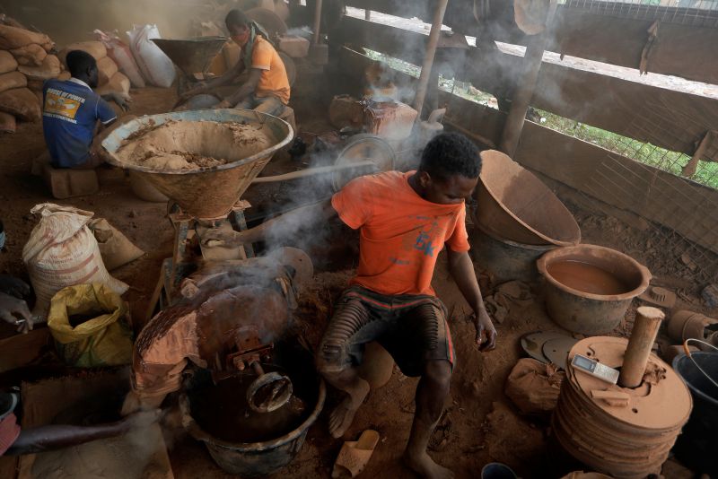 An informal gold miner uses his T-shirt to cover his face from the dust coming from a rock-breaking machine at the site of Nsuaem Top, Ghana November 24, 2018. REUTERS/Zohra Bensemra