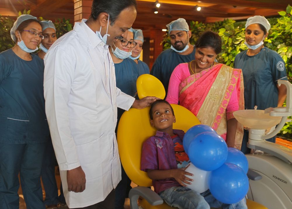 Doctors pose with a 7-year-old boy, whose tooth-like structures were removed from his mouth, at a hospital in Chennai, India, August 2, 2019.  REUTERS/P. Ravikumar