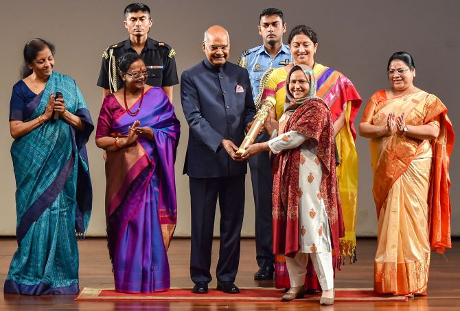  Arifa Jan receives 'Nari Shakti Puraskar 2019' on International Women's Day from President Ram Nath Kovind as First Lady Savita Kovind, Union Ministers Smriti Irani and Nirmala Sitharaman look on, at Rashtrapati Bhavan Cultural Center in New Delhi, Sunday, March 8, 2020. Hailing from Kashmir, Jan has taken the task to revive the once famed handicraft Numdha, the traditional embroidered rug. (PTI Photo/Manvender Vashist)(